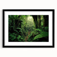 Framed rainforest landscape wall art with a black mat, showcasing vibrant green foliage and serene tropical scenery, perfect for home decor.