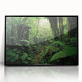 Framed acrylic wall art featuring a vibrant rainforest landscape design with lush greenery and colorful flora, presented in a sleek black frame for modern decor.