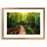 Framed wall art showcasing a vibrant rainforest landscape design, featuring lush green foliage and intricate details, accented with a gold frame and mat. Ideal for nature lovers and interior decor enthusiasts.