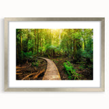 Framed rainforest landscape wall art in a silver frame with a mat, showcasing vibrant green foliage and intricate details, perfect for home decor.