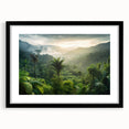 Framed wall art depicting a vibrant rainforest landscape, featuring lush greenery and vivid colors, with a sleek black frame and mat, perfect for home decor.