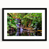 Framed rainforest landscape wall art with a black mat and sleek frame, showcasing vibrant green foliage and serene natural elements, perfect for home decor.