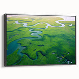 Framed canvas artwork depicting a lush rainforest landscape, featuring vibrant green foliage and intricate details, displayed in a sleek black frame from the side.