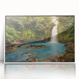 Framed acrylic wall art featuring a vibrant rainforest landscape design, with lush greenery and colorful flora, presented in a sleek white frame for modern decor.