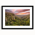 Framed wall art collection featuring a vibrant rainforest landscape design, with a sleek black frame and mat, ideal for enhancing home decor and adding a touch of nature.