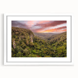 Framed rainforest landscape wall art featuring vibrant green foliage and lush trees, set in a sleek white frame with a mat, perfect for enhancing any interior decor.