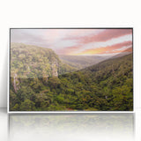 Framed acrylic wall art showcasing a vibrant rainforest landscape with lush greenery and tropical plants, highlighting nature's beauty in a modern white frame.