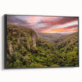 Framed canvas wall art showcasing a vibrant rainforest landscape design with lush greenery and vibrant colors, presented in a sleek black frame, perfect for home decor.