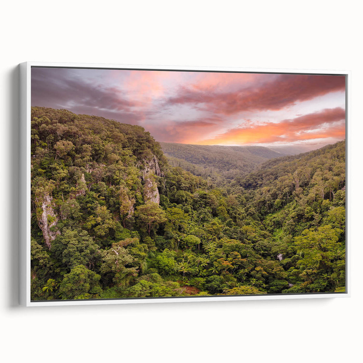Framed canvas wall art showcasing a vibrant rainforest landscape design with lush green foliage and colorful flora, presented in a modern white frame. Ideal for home decor.