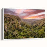 Framed canvas wall art showcasing a vibrant rainforest landscape design with lush green foliage and colorful flora, presented in a modern white frame. Ideal for home decor.