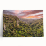 Stretched canvas artwork showcasing a vibrant rainforest landscape, featuring lush green foliage and colorful tropical flowers, perfect for nature-themed decor.