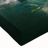 Vibrant close-up of a rainforest-themed stretched canvas wall art piece, displaying lush green foliage and intricate details, perfect for nature-inspired decor.