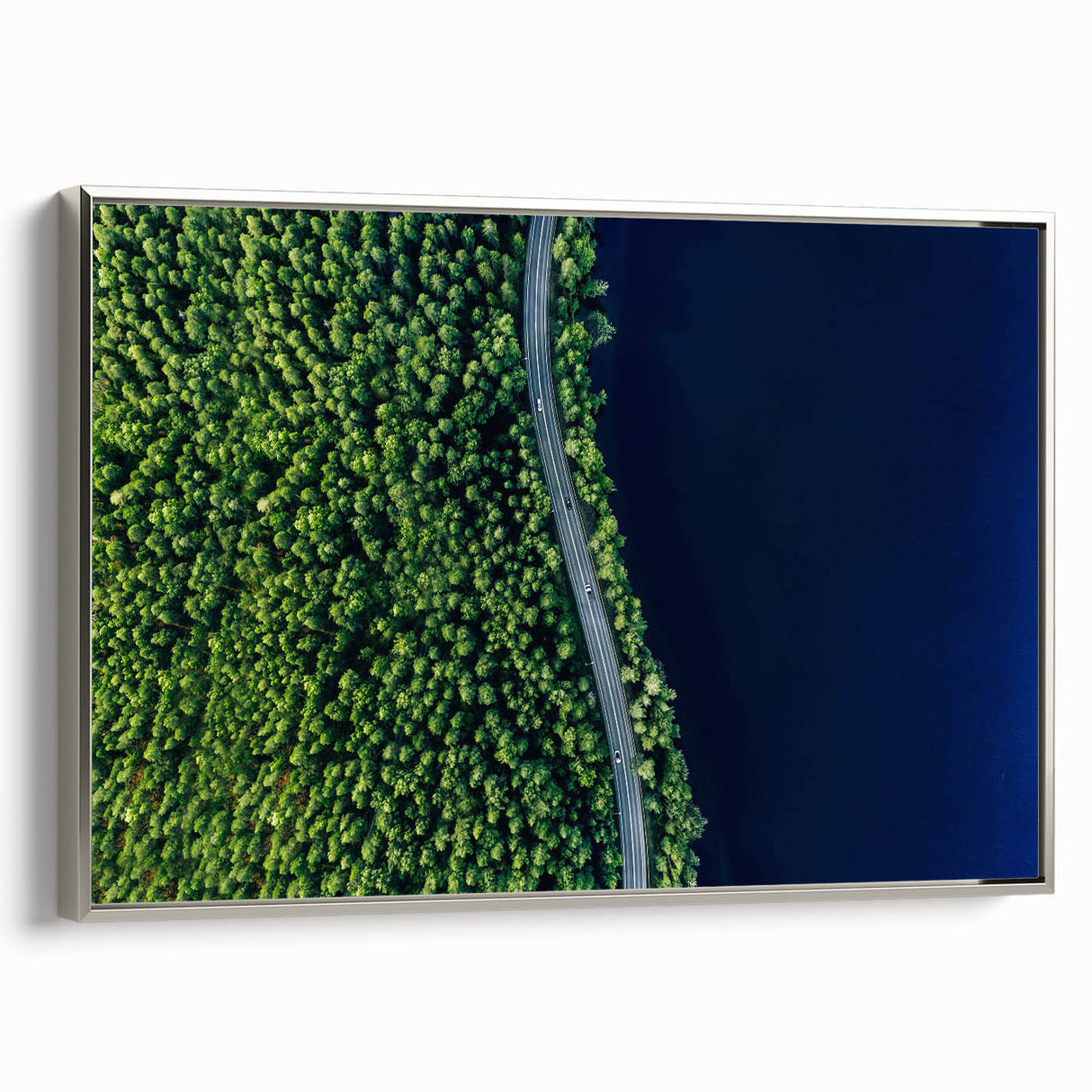 Framed canvas wall art showcasing a serene landscape design featuring winding roads and lush greenery, complemented by a sleek silver frame, perfect for home decor.