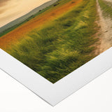 Vibrant rolled canvas art depicting a serene landscape with winding roads and lush greenery, ideal for home decor, packaged securely in a cardboard tube for safe delivery.