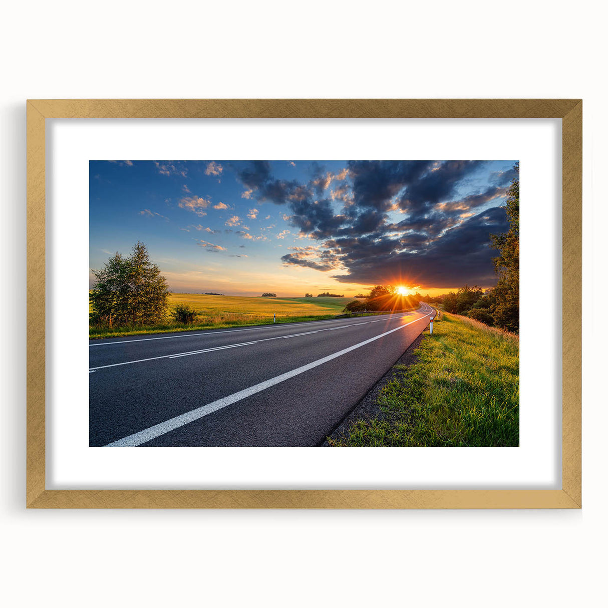 Framed wall art featuring a scenic landscape with a road design, set in a gold frame with a white mat, enhancing any modern home decor.