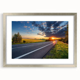 Framed wall art showcasing a serene landscape road design, featuring a silver mat and sleek front view, perfect for enhancing modern home decor.