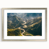 Framed wall art featuring a scenic landscape road design in a sleek silver frame with matting. Ideal for modern home decor, enhancing living spaces with elegance.