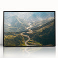 Framed acrylic wall art featuring a scenic landscape with winding roads, presented in a sleek black frame, ideal for modern home decor. The vibrant colors and intricate details evoke a sense of adventure and tranquility, enhancing any living space.