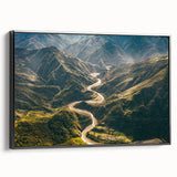 Framed black canvas wall art showcasing a scenic landscape with winding roads, perfect for modern home decor and enhancing interior aesthetics.