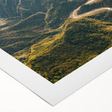 Rolled canvas artwork showcasing a vibrant landscape with winding roads and lush greenery, ideal for home decor. Packaged securely in a protective tube for delivery.