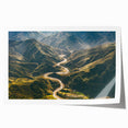 Rolled print showcasing a vibrant landscape road design in rich colors, ideal for home decor, packaged securely in a protective cardboard tube for delivery.