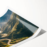 Rolled print of a serene landscape featuring winding roads under a vibrant sunset, ideal for home decor, showcasing rich colors and detailed textures.