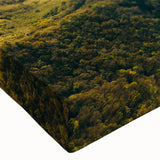 Close-up of a stretched canvas wall art piece showcasing a vibrant landscape design with winding roads, rich colors, and intricate details, perfect for home decor.