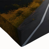 Close-up of a stretched canvas wall art piece showcasing a vibrant landscape design, featuring winding roads through lush greenery, ideal for modern home decor.