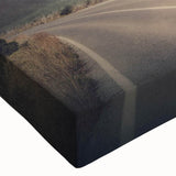 Close-up of a vibrant stretched canvas showcasing a landscape road design in rich colors, perfect for modern home decor and artistic wall displays, adding depth and style to any room.