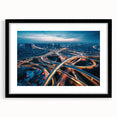 Framed wall art featuring a serene landscape design with winding roads, presented in a sleek black frame and a white mat, ideal for modern home decor.