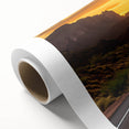 Rolled canvas wall art showcasing a vibrant landscape design with winding roads and lush greenery, ideal for home decor, packaged securely in a cardboard tube.