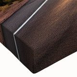 Close-up of a vibrant stretched canvas wall art featuring a scenic landscape with winding roads, perfect for home decor, showcasing rich colors and intricate details.