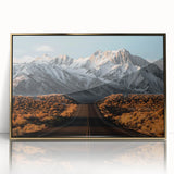 Framed wall art featuring a stunning landscape design with a winding road, highlighted by vibrant colors and a sleek gold frame, perfect for home decor.