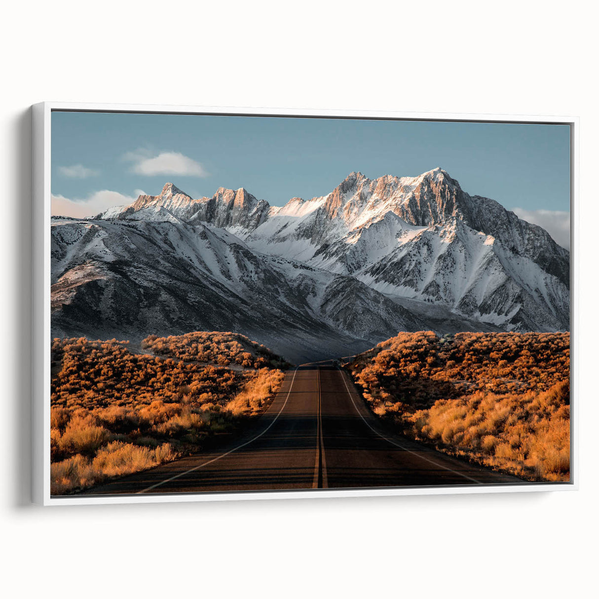 Framed canvas wall art featuring a scenic landscape design with winding roads, displayed with a white frame, ideal for modern home decor and artistic ambiance.