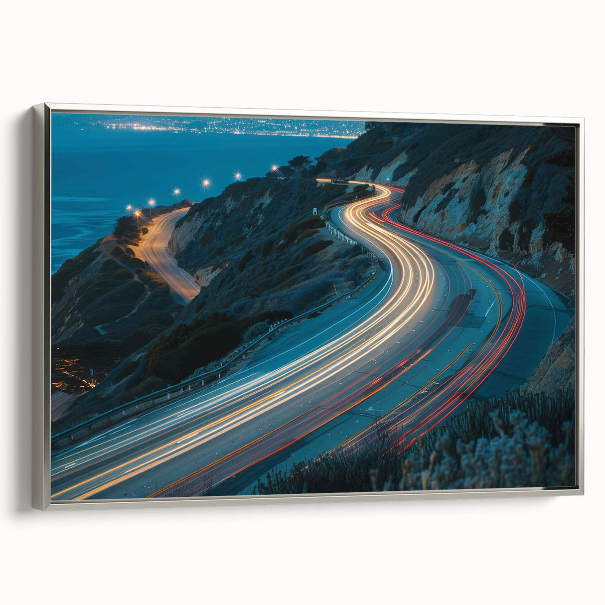 Framed canvas wall art showcasing a serene landscape with winding roads and lush greenery, accented by a sleek silver frame, ideal for modern home decor.