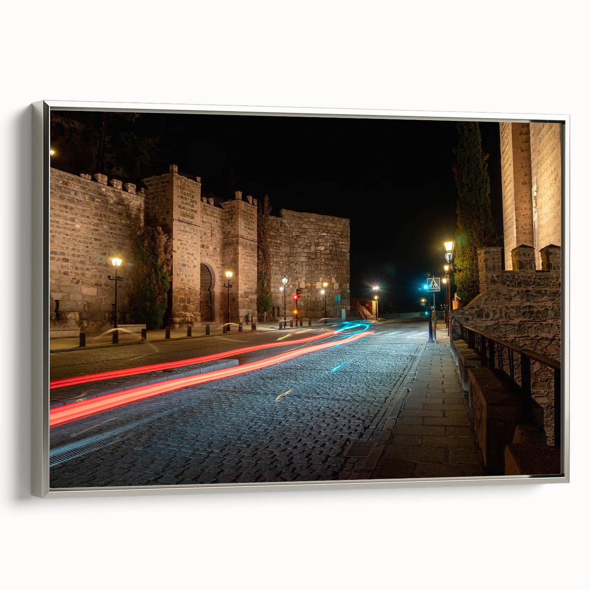 Framed canvas wall art depicting a serene landscape with winding roads, soft green hills, and a silver frame, perfect for enhancing modern home decor.