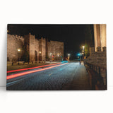 Stretched canvas wall art depicting a serene landscape with winding roads and vibrant greenery, elegantly leaning against a neutral wall, enhancing modern decor.