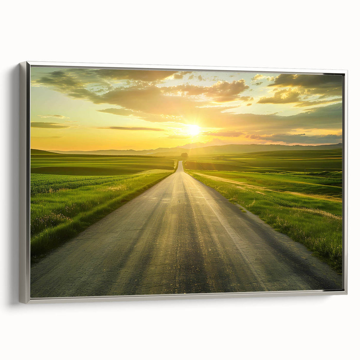 Framed canvas wall art featuring a serene landscape with winding roads and lush greenery, accented by a sleek silver frame, perfect for modern home decor.