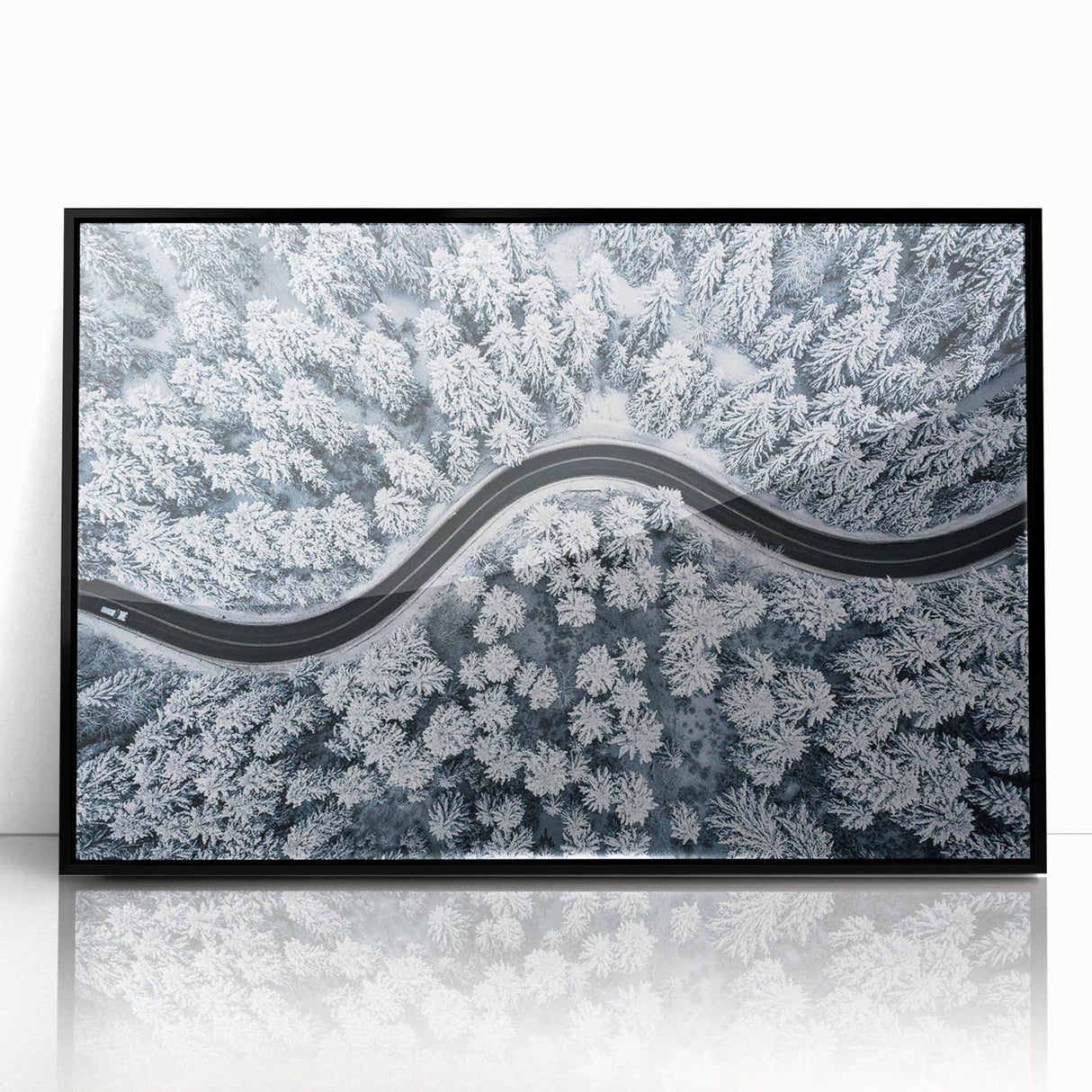Framed acrylic wall art showcasing a scenic landscape with winding roads, featuring a sleek black frame, perfect for modern home decor. Ideal for enhancing interior aesthetics.