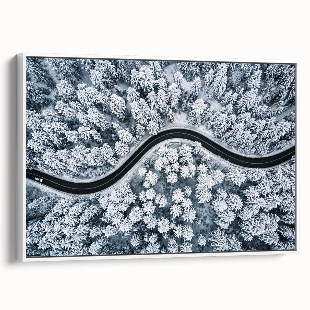 Framed canvas wall art showcasing a serene landscape with winding roads and lush greenery, presented from a side view against a white background, perfect for home decor.