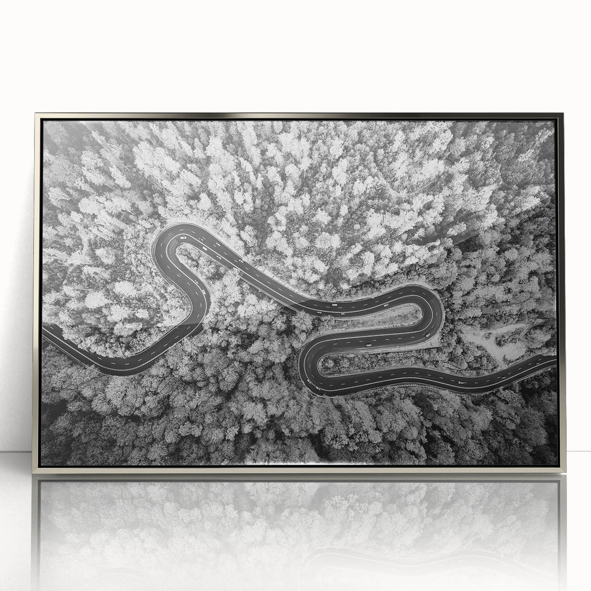 Framed acrylic wall art featuring a modern landscape design with a silver border, showcasing a serene road scene, perfect for enhancing contemporary home decor.