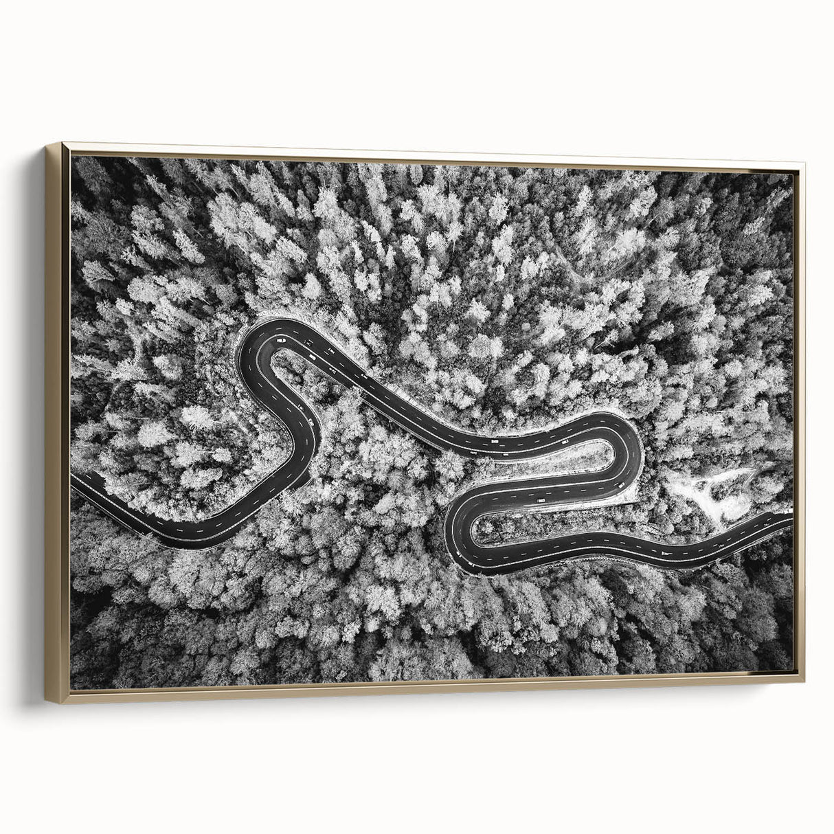 Framed canvas wall art featuring a scenic landscape with winding roads and lush greenery, accented with a gold frame, ideal for modern home decor.