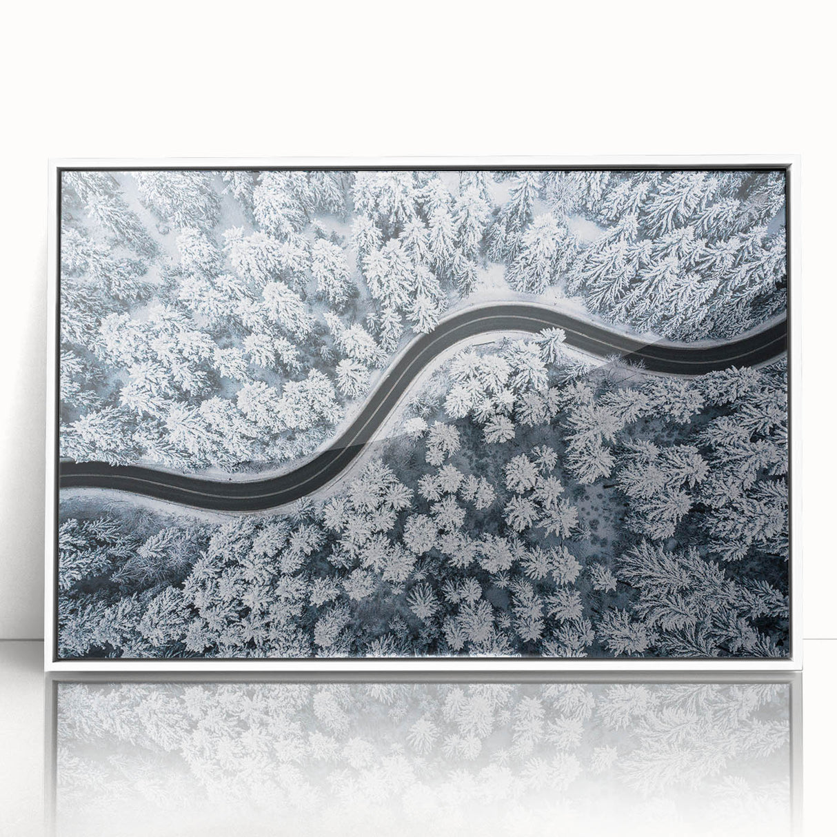 Framed wall art featuring a vibrant landscape scene with winding roads and lush greenery, displayed in a sleek white frame, ideal for modern home decor.