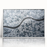 Framed wall art featuring a vibrant landscape scene with winding roads and lush greenery, displayed in a sleek white frame, ideal for modern home decor.