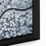 Close-up of a framed canvas artwork showcasing a vibrant, abstract landscape with winding roads and rich earthy tones, perfect for modern home decor.