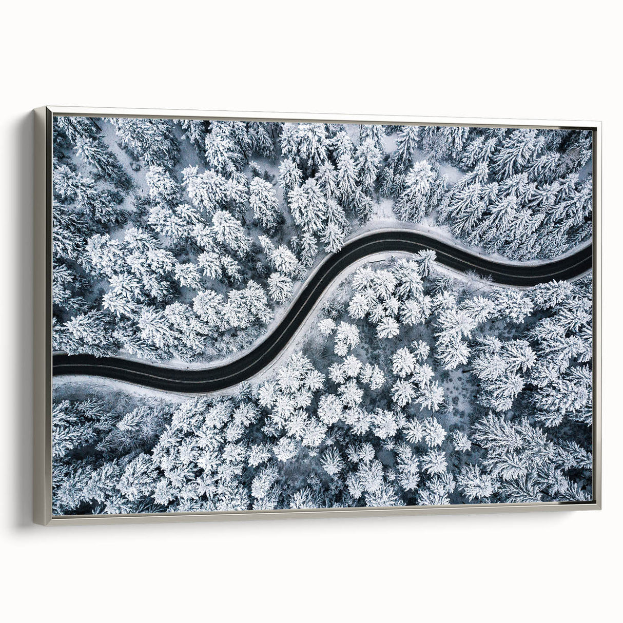 Framed canvas wall art showcasing a scenic landscape with winding roads, set in a sleek silver frame, perfect for home decor and modern aesthetics.