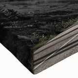 Close-up view of a stretched canvas artwork showcasing a vibrant landscape design with winding roads, rich colors, and detailed textures, perfect for home decor.
