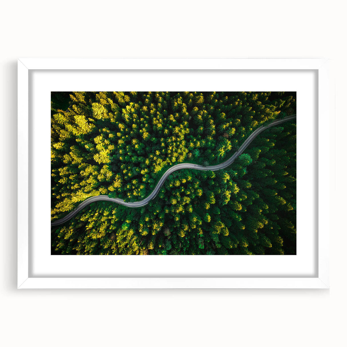Framed wall art featuring a scenic landscape with winding roads, set against a bright white mat and frame, perfect for home decor in modern spaces.