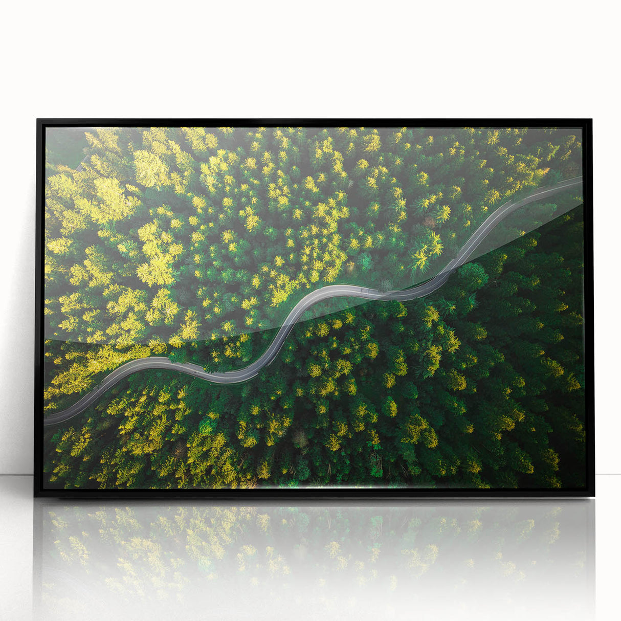 Framed black acrylic wall art showcasing a vibrant landscape road design, perfect for modern home decor. The artwork adds a stylish touch to any interior setting.