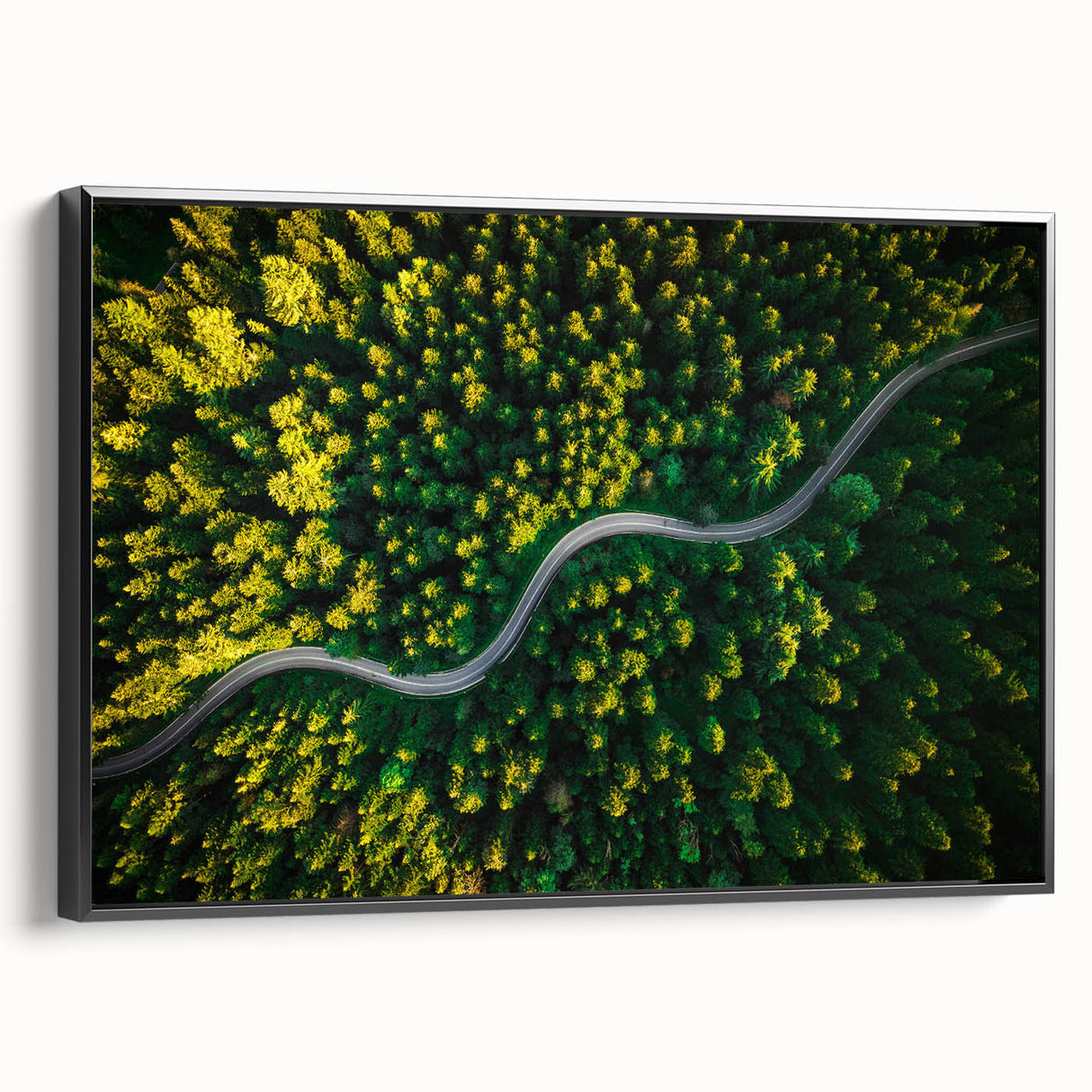 Framed canvas wall art showcasing a scenic landscape with winding roads and lush greenery, presented in a sleek black frame, perfect for modern decor.